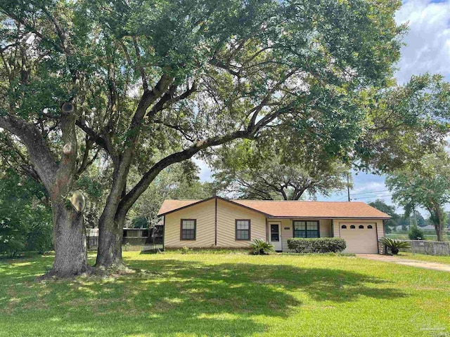 ranch-style home with a front lawn and a garage