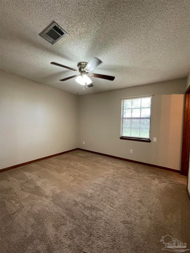 carpeted empty room with a textured ceiling and ceiling fan