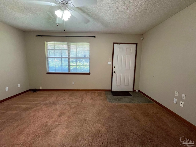 carpeted empty room with a textured ceiling and ceiling fan