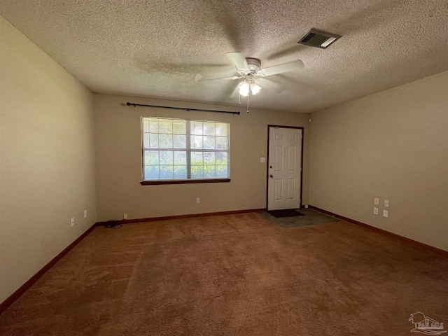 unfurnished room with a textured ceiling, carpet, and ceiling fan