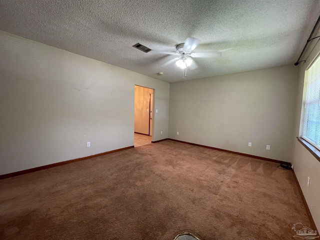 carpeted spare room with a textured ceiling and ceiling fan