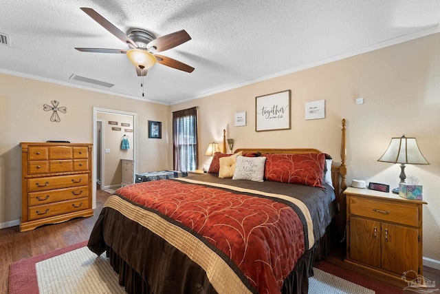 bedroom featuring ornamental molding, a textured ceiling, ceiling fan, and dark wood-type flooring