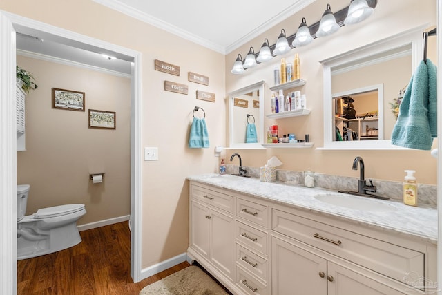 bathroom featuring vanity, toilet, wood-type flooring, and ornamental molding