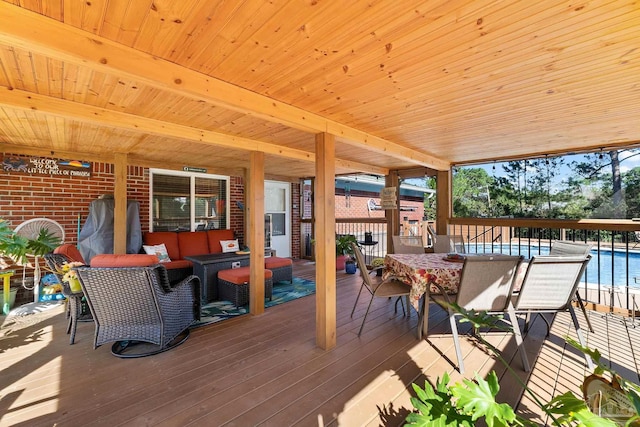 wooden terrace featuring an outdoor hangout area and a pool