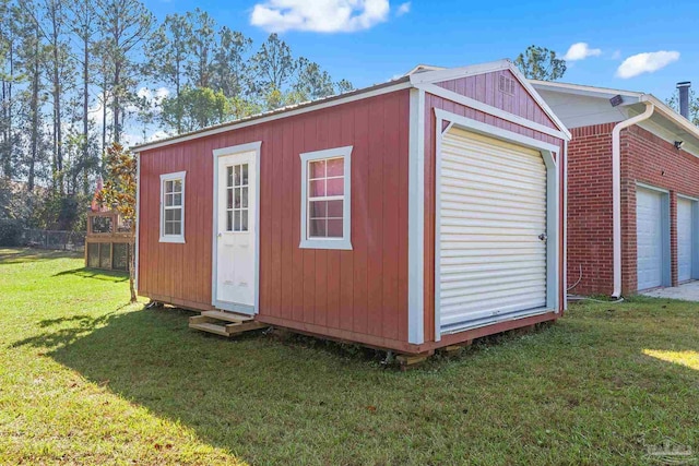 view of outbuilding featuring a garage and a lawn