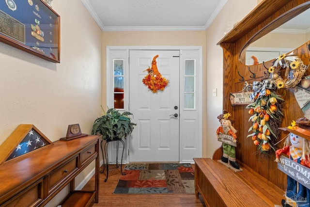 entryway with wood-type flooring, a textured ceiling, and ornamental molding