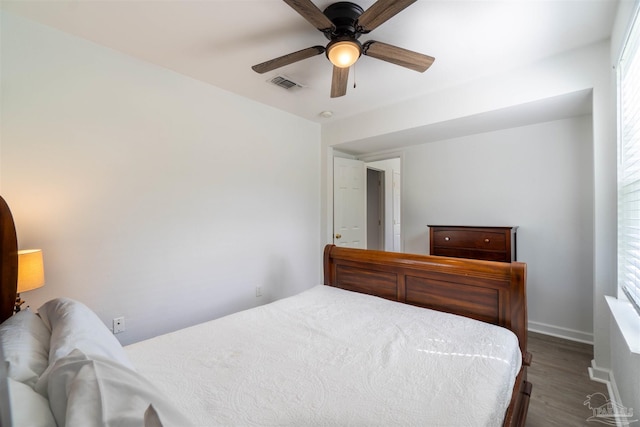 bedroom with multiple windows, ceiling fan, and hardwood / wood-style floors