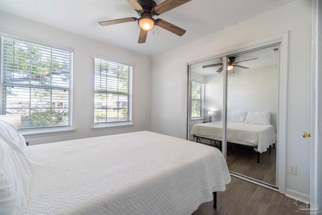 bedroom with a closet, hardwood / wood-style floors, and ceiling fan