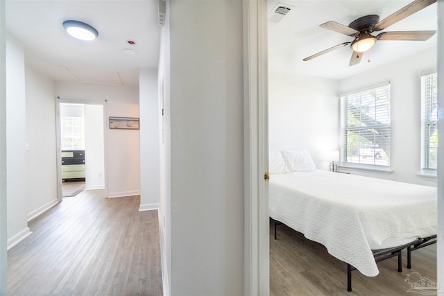 bedroom with ceiling fan and light wood-type flooring