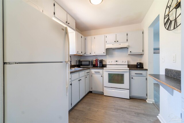 kitchen with light wood-type flooring, white appliances, and white cabinets