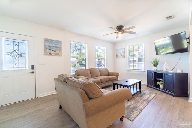 living room featuring ceiling fan and light wood-type flooring