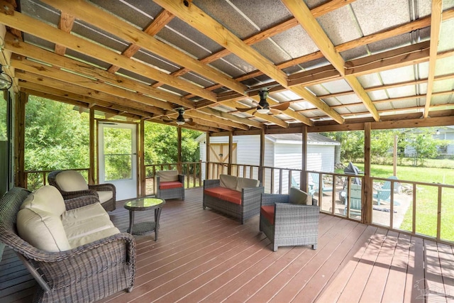 sunroom featuring ceiling fan