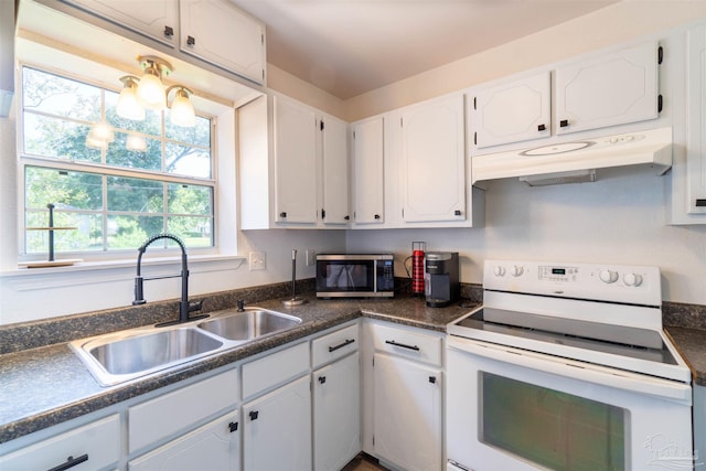 kitchen with a notable chandelier, sink, white cabinetry, and white electric stove