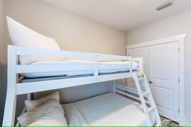 bedroom featuring visible vents and a closet