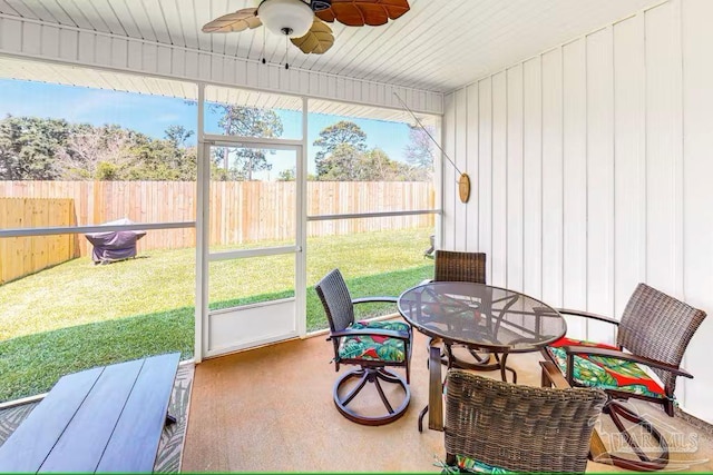 sunroom featuring outdoor dining space and ceiling fan