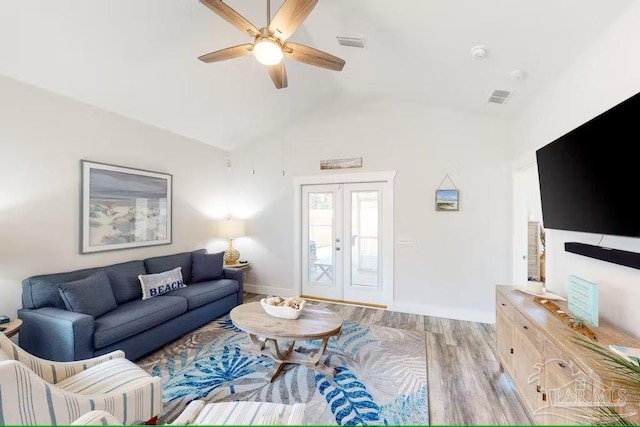 living area with light wood-style flooring, visible vents, vaulted ceiling, and a ceiling fan
