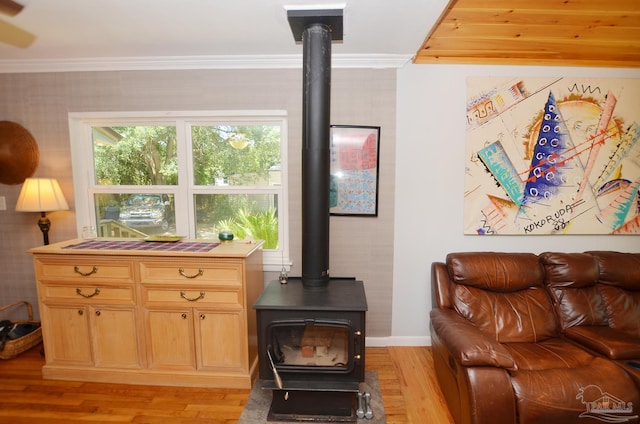 2153 Bergren Rd, Gulf Breeze, FL 32563 - living area featuring a wood stove, crown molding, and light wood-style floors