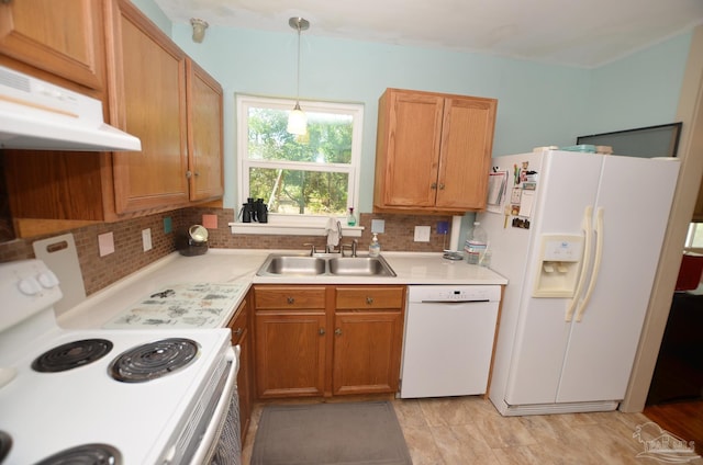 2153 Bergren Rd, Gulf Breeze, FL 32563 - kitchen featuring white appliances, under cabinet range hood, tasteful backsplash, and light countertops