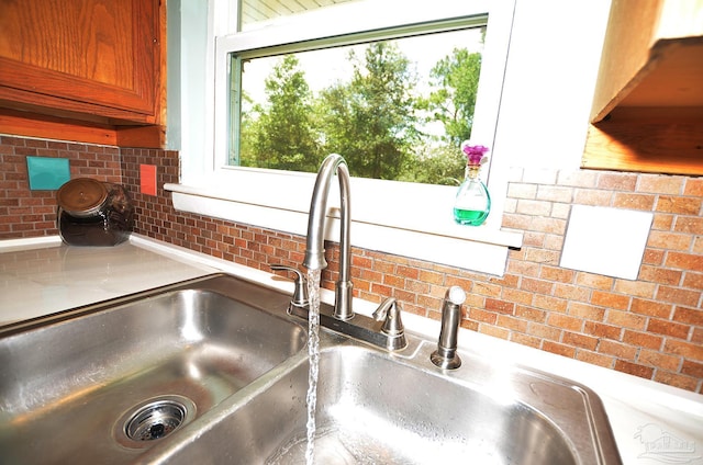 2153 Bergren Rd, Gulf Breeze, FL 32563 - kitchen view of backsplash, light countertops, and brown cabinets