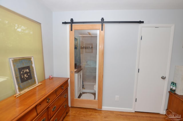 2153 Bergren Rd, Gulf Breeze, FL 32563 - bedroom featuring light wood-style flooring and ensuite bath