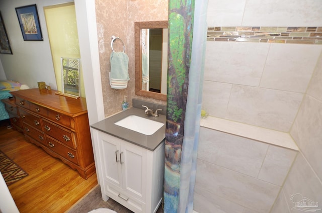 2153 Bergren Rd, Gulf Breeze, FL 32563 - bathroom featuring wood finished floors, vanity, and wallpapered walls