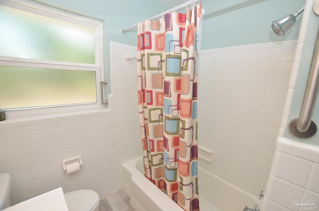 2153 Bergren Rd, Gulf Breeze, FL 32563 - bathroom featuring tile walls and shower / bath combo with shower curtain