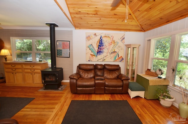 2153 Bergren Rd, Gulf Breeze, FL 32563 - living area with vaulted ceiling, a wood stove, wood finished floors, wood ceiling, and ornamental molding