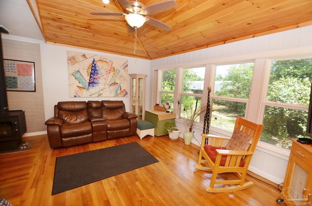 2153 Bergren Rd, Gulf Breeze, FL 32563 - living area with a wood stove, wood ceiling, vaulted ceiling, wood finished floors, and a ceiling fan