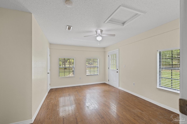 6136 Beasley Rd, Crestview, FL 32536 - unfurnished room with attic access, a textured ceiling, hardwood / wood-style flooring, a smoke detector, and a ceiling fan