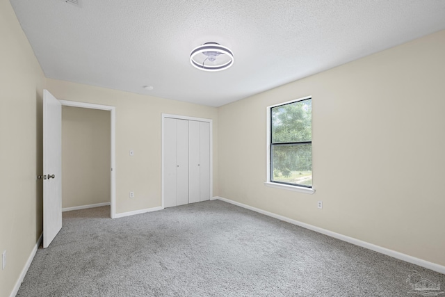 6136 Beasley Rd, Crestview, FL 32536 - unfurnished bedroom featuring carpet floors, a closet, and a textured ceiling