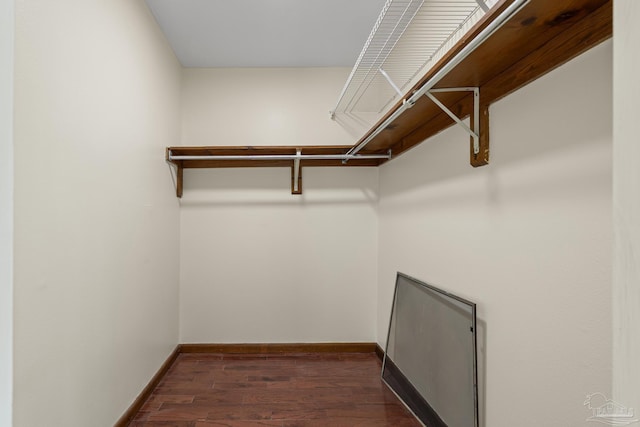 6136 Beasley Rd, Crestview, FL 32536 - walk in closet with dark wood-style flooring