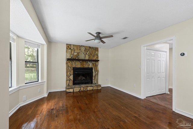 6136 Beasley Rd, Crestview, FL 32536 - unfurnished living room with wood-type flooring, ceiling fan, and a fireplace
