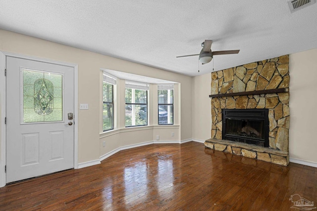 6136 Beasley Rd, Crestview, FL 32536 - foyer entrance with a ceiling fan, hardwood / wood-style flooring, a textured ceiling, and a fireplace