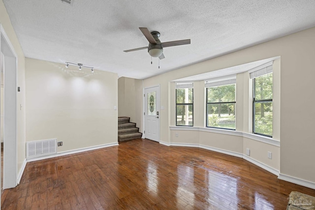 6136 Beasley Rd, Crestview, FL 32536 - unfurnished room with a ceiling fan, a textured ceiling, wood-type flooring, and plenty of natural light
