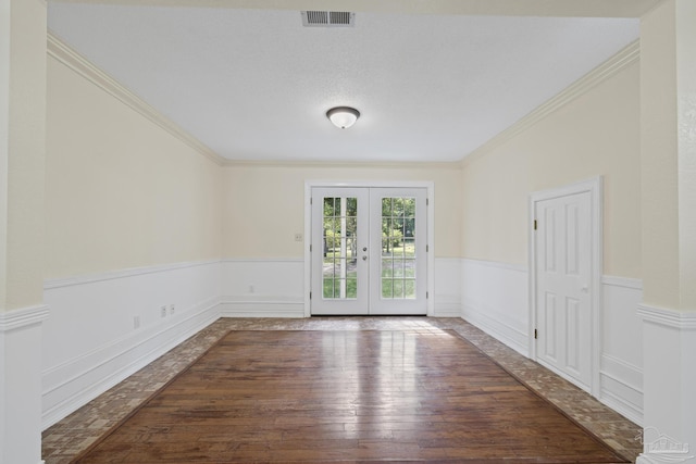6136 Beasley Rd, Crestview, FL 32536 - unfurnished room featuring french doors, wood-type flooring, wainscoting, and crown molding