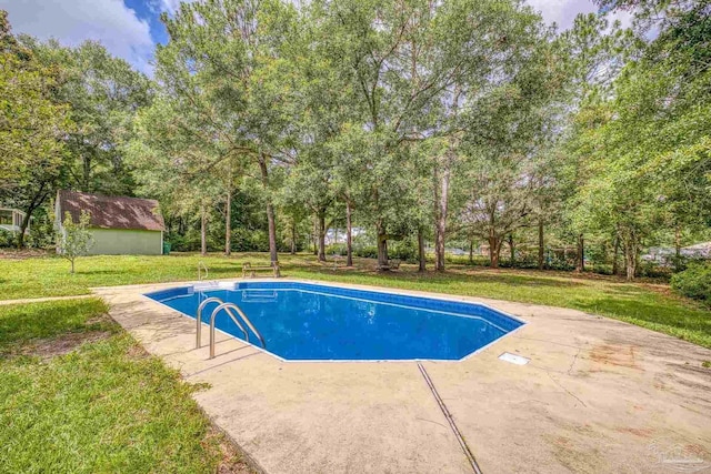 6136 Beasley Rd, Crestview, FL 32536 - outdoor pool featuring a patio area, a lawn, and view of scattered trees