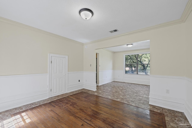 6136 Beasley Rd, Crestview, FL 32536 - unfurnished room with crown molding, hardwood / wood-style floors, and a wainscoted wall