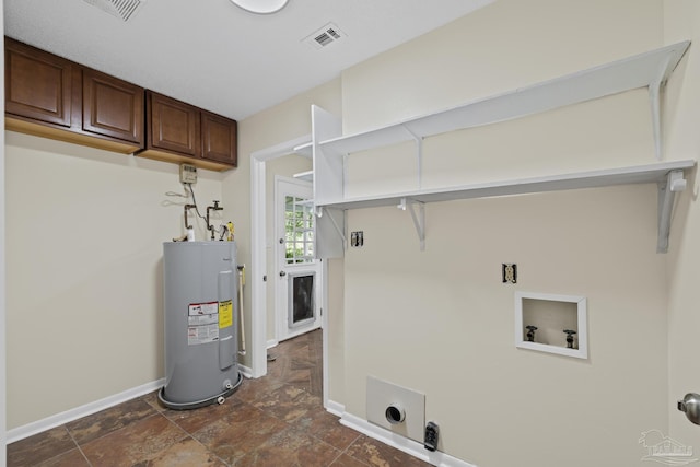 6136 Beasley Rd, Crestview, FL 32536 - laundry room featuring electric water heater, electric dryer hookup, washer hookup, cabinet space, and dark stone finish flooring