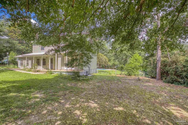 6136 Beasley Rd, Crestview, FL 32536 - view of grassy yard featuring a porch