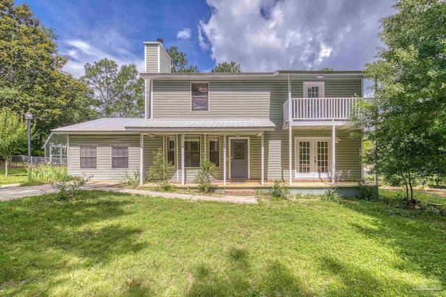 6136 Beasley Rd, Crestview, FL 32536 - rear view of house featuring french doors, a chimney, a yard, and covered porch