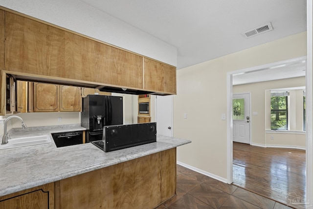 6136 Beasley Rd, Crestview, FL 32536 - kitchen featuring black appliances, a peninsula, and brown cabinets
