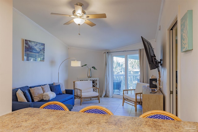 tiled living room featuring lofted ceiling, ceiling fan, and ornamental molding