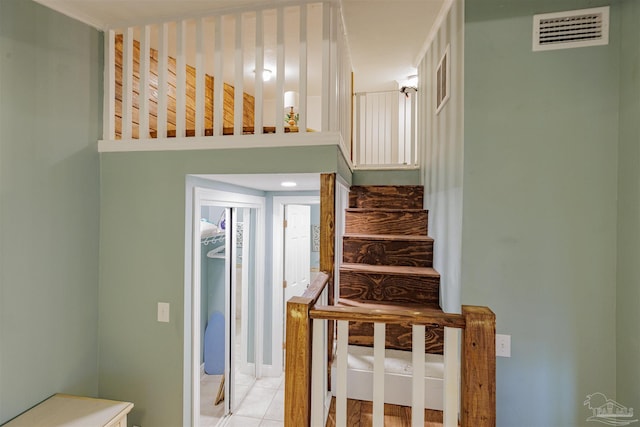 staircase featuring tile patterned floors