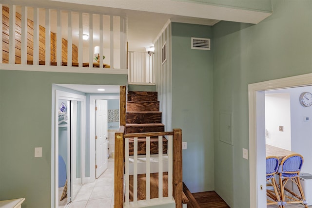 stairs with tile patterned floors