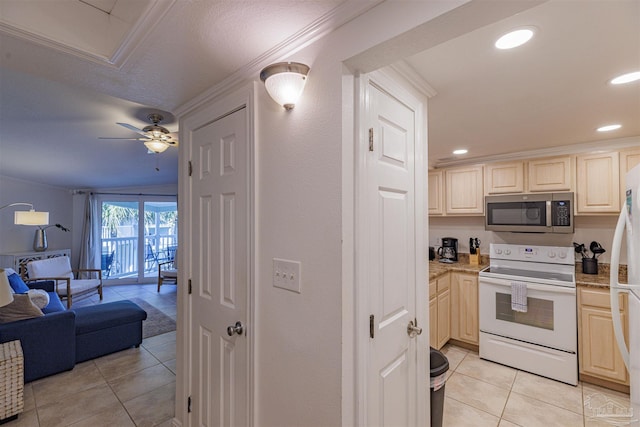 kitchen featuring crown molding, ceiling fan, light tile patterned flooring, and white appliances