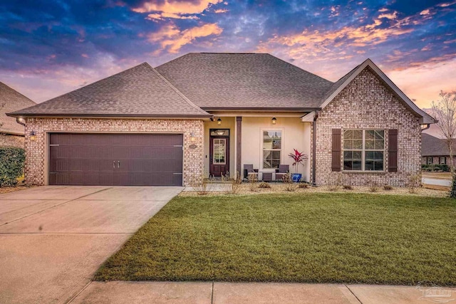 view of front of house featuring a garage, concrete driveway, brick siding, and a front yard