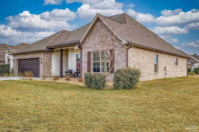 view of front of house featuring a garage and a front lawn