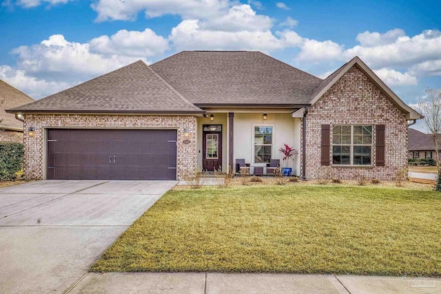 view of front of house with a garage and a front yard