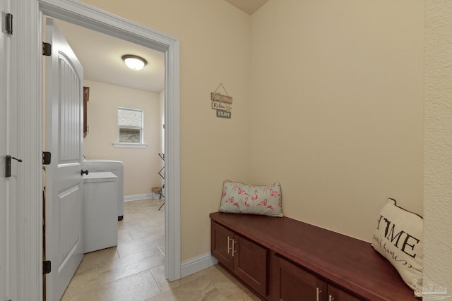 clothes washing area featuring washer / clothes dryer and light tile patterned flooring