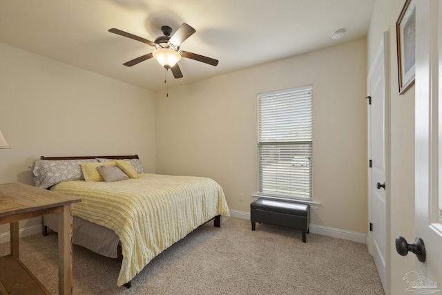 bedroom featuring light carpet and ceiling fan